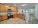 Well-equipped kitchen featuring stainless steel appliances, wooden cabinets, and tiled backsplash at 2162 Spikerush Way, Buford, GA 30519