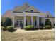 Inviting traditional home with a manicured lawn, stately columns and a covered front porch with elegant double-door entrance at 225 Mountain Vista Blvd, Canton, GA 30115