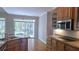 Eat-in kitchen features stainless steel appliances, granite countertops, wood cabinets, and an exterior sliding glass door at 225 Mountain Vista Blvd, Canton, GA 30115