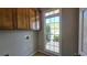 Bright laundry room with a large window and storage cabinets at 225 Mountain Vista Blvd, Canton, GA 30115