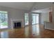 Open-concept living area with hardwood floors, a fireplace, sliding glass doors, and a breakfast bar connecting to the kitchen at 225 Mountain Vista Blvd, Canton, GA 30115