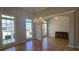 Elegant formal living and dining room featuring hardwood flooring, crown molding, a chandelier and large windows at 225 Mountain Vista Blvd, Canton, GA 30115