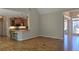 Open floor plan with hardwood floors, seamlessly connecting the living room, kitchen with breakfast bar, and dining area at 225 Mountain Vista Blvd, Canton, GA 30115