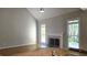 Bright living room featuring hardwood floors, a fireplace, large windows, and neutral decor at 225 Mountain Vista Blvd, Canton, GA 30115