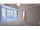 Carpeted bedroom features a tray ceiling, a ceiling fan, and large bright windows at 225 Mountain Vista Blvd, Canton, GA 30115