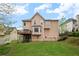 Exterior view of the home showcasing a large grassy backyard and a deck at 3025 Kaley Nw Dr, Kennesaw, GA 30152