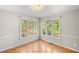 Cozy bedroom featuring hardwood floors and lots of natural light with views of the backyard at 3025 Kaley Nw Dr, Kennesaw, GA 30152
