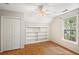 Bedroom features a ceiling fan, hardwood floors, a closet, and built-in shelving at 3025 Kaley Nw Dr, Kennesaw, GA 30152