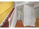Inviting foyer with hardwood floors, staircase, and a view into the kitchen and living areas at 3025 Kaley Nw Dr, Kennesaw, GA 30152