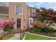 Charming two-story brick home with a beautiful arched window, well-manicured lawn, and flowering shrubs at 3025 Kaley Nw Dr, Kennesaw, GA 30152