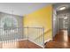 Hallway with hardwood floors, a decorative wall and an arched window allowing natural light at 3025 Kaley Nw Dr, Kennesaw, GA 30152