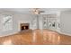 Spacious living room with hardwood floors, fireplace, and large windows providing ample natural light at 3025 Kaley Nw Dr, Kennesaw, GA 30152