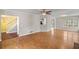 Open concept living room featuring hardwood floors, a ceiling fan, and a view into the foyer and kitchen at 3025 Kaley Nw Dr, Kennesaw, GA 30152
