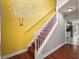 Bright staircase featuring a decorative tree decal, hardwood flooring and a view of the kitchen at 3025 Kaley Nw Dr, Kennesaw, GA 30152