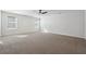 Spacious bedroom with a ceiling fan, two windows, and plush carpeting at 358 Orwell Dr, Social Circle, GA 30025