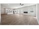 Bright, open-concept living room with hardwood floors, a fireplace, and a modern kitchen at 358 Orwell Dr, Social Circle, GA 30025