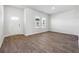 Large open living room with laminate wood floors and plenty of light at 358 Orwell Dr, Social Circle, GA 30025