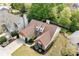 Aerial view of a home with mature landscaping, a two-car garage, and a well-maintained roof at 1483 Chamirey Sw Dr, Marietta, GA 30008