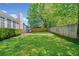 Expansive backyard featuring well-maintained lawn, privacy fencing, and mature trees at 1483 Chamirey Sw Dr, Marietta, GA 30008
