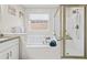 Clean bathroom showcases a shower and tub with a marble countertop vanity at 1483 Chamirey Sw Dr, Marietta, GA 30008