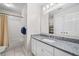 This is a bathroom with vanity, granite countertops, and shower with a curtain at 1483 Chamirey Sw Dr, Marietta, GA 30008