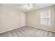 A tan painted bedroom features a ceiling fan and a view of a window at 1483 Chamirey Sw Dr, Marietta, GA 30008