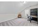 A spacious bonus room features a built-in desk and an office chair and carpet at 1483 Chamirey Sw Dr, Marietta, GA 30008