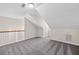 An open bonus room with gray patterned carpeting and neutral paint with access to an upstairs landing at 1483 Chamirey Sw Dr, Marietta, GA 30008