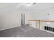 Open carpeted hallway with a railing and natural light at 1483 Chamirey Sw Dr, Marietta, GA 30008