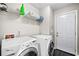 Laundry room featuring washer, dryer, shelving and a door leading outside at 1483 Chamirey Sw Dr, Marietta, GA 30008