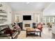 Bright living room with fireplace, large windows, and hardwood floors at 1483 Chamirey Sw Dr, Marietta, GA 30008