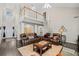 Open-concept living room featuring high ceilings, a spiral staircase, and comfortable leather seating at 1483 Chamirey Sw Dr, Marietta, GA 30008