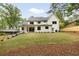 A modern farmhouse boasts a huge backyard with manicured lawn and dark trim windows at 1501 Harts Mill Ne Rd, Brookhaven, GA 30319