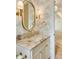 Elegant bathroom featuring a marble countertop, gold fixtures, and decorative wallpaper at 1501 Harts Mill Ne Rd, Brookhaven, GA 30319