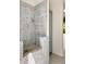 Stunning bathroom shower with blue and white patterned tile and a sleek shower head at 1501 Harts Mill Ne Rd, Brookhaven, GA 30319