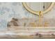 Close-up of a luxurious marble countertop with gold faucet and designer wallpaper at 1501 Harts Mill Ne Rd, Brookhaven, GA 30319