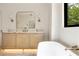 Bathroom featuring a freestanding tub, wood vanity, and a view of the backyard at 1501 Harts Mill Ne Rd, Brookhaven, GA 30319