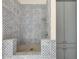 Stunning bathroom shower with blue and white patterned tile and a sleek shower head at 1501 Harts Mill Ne Rd, Brookhaven, GA 30319