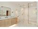 Bright bathroom featuring glass enclosed shower, dual vanities, and modern tile flooring at 1501 Harts Mill Ne Rd, Brookhaven, GA 30319