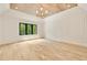 Spacious bedroom featuring tray ceiling, hardwood floors, elegant lighting and a backyard view at 1501 Harts Mill Ne Rd, Brookhaven, GA 30319