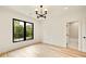 Bright, spacious bedroom featuring hardwood floors, a large window, and modern lighting at 1501 Harts Mill Ne Rd, Brookhaven, GA 30319