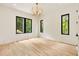 Bright bedroom with three large windows offering nature views and modern lighting at 1501 Harts Mill Ne Rd, Brookhaven, GA 30319