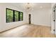 Bright bedroom featuring hardwood floors, modern lighting, large window, and closet at 1501 Harts Mill Ne Rd, Brookhaven, GA 30319