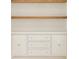 A white built-in cabinet with drawers and clear knobs and wood shelves at 1501 Harts Mill Ne Rd, Brookhaven, GA 30319