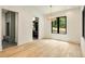 Bright dining room boasts hardwood floors, modern lighting, and a view of the lush greenery outside at 1501 Harts Mill Ne Rd, Brookhaven, GA 30319