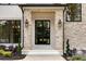 Stylish front entryway with stone columns, black trim windows, and an elegant front door at 1501 Harts Mill Ne Rd, Brookhaven, GA 30319