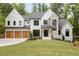Stunning two-story home featuring a mix of brick, stone, and painted siding with a three-car garage at 1501 Harts Mill Ne Rd, Brookhaven, GA 30319