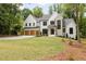Beautiful home with a manicured lawn, boasting stone, painted brick and siding, plus a three-car garage at 1501 Harts Mill Ne Rd, Brookhaven, GA 30319
