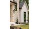 Close-up of the home's exterior showcasing stone, siding, black trim windows, and professionally landscaped grounds at 1501 Harts Mill Ne Rd, Brookhaven, GA 30319