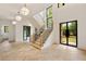 Elegant foyer featuring high ceilings, herringbone floors, black trim windows, and a staircase at 1501 Harts Mill Ne Rd, Brookhaven, GA 30319